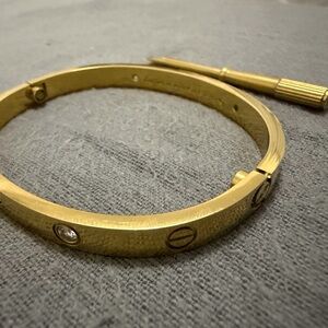 Gold-Tone Screw Accent Bangle Bracelet with Clear Crystal Details